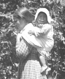 Cherokee woman carrying baby in the traditional way