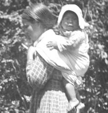 Cherokee woman carrying baby in the traditional way